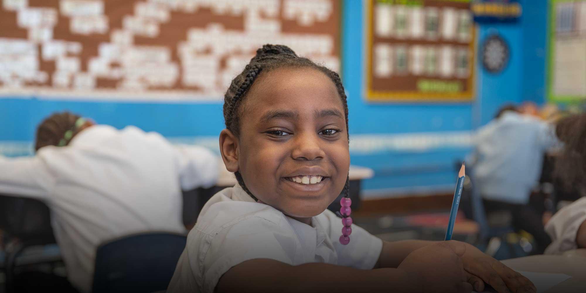 Smiling student sitting at desk